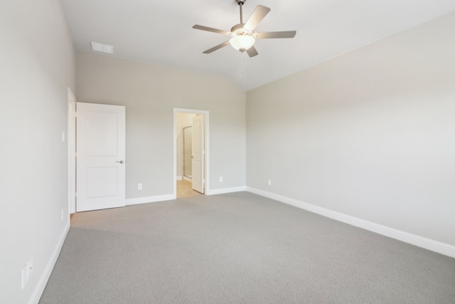 unfurnished bedroom with vaulted ceiling, ceiling fan, ensuite bathroom, and light colored carpet