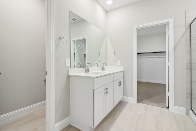 bathroom with an enclosed shower and vanity