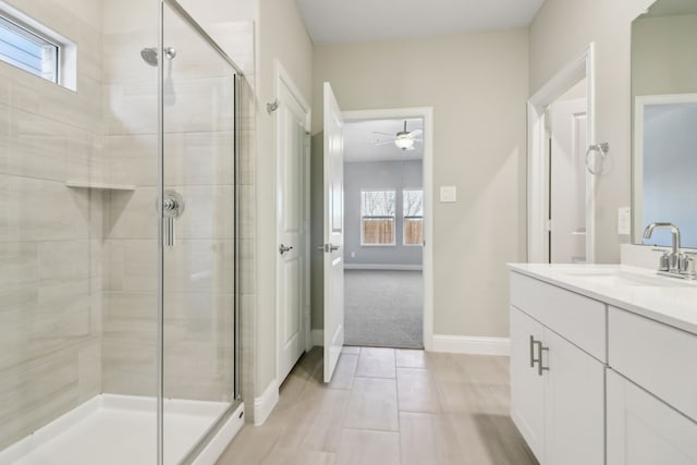 bathroom with a shower with shower door, tile patterned flooring, vanity, and a healthy amount of sunlight