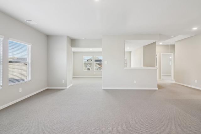 carpeted empty room with a wealth of natural light