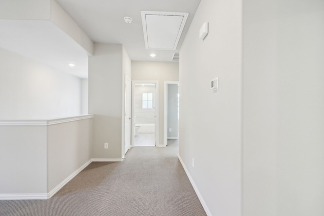 hallway featuring light colored carpet