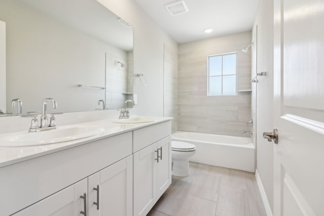 full bathroom with toilet, vanity, and tiled shower / bath combo