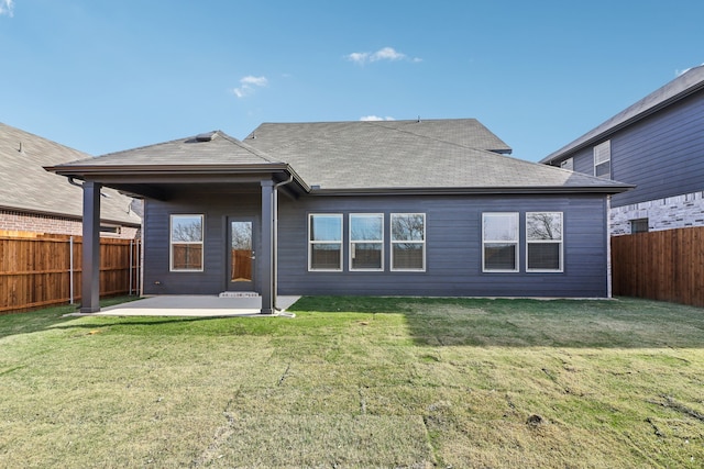 rear view of property with a yard and a patio