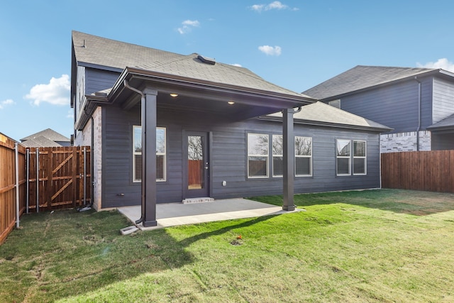 rear view of house featuring a patio area and a yard