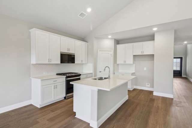 kitchen featuring white cabinetry, stainless steel gas range oven, a kitchen island with sink, high vaulted ceiling, and sink