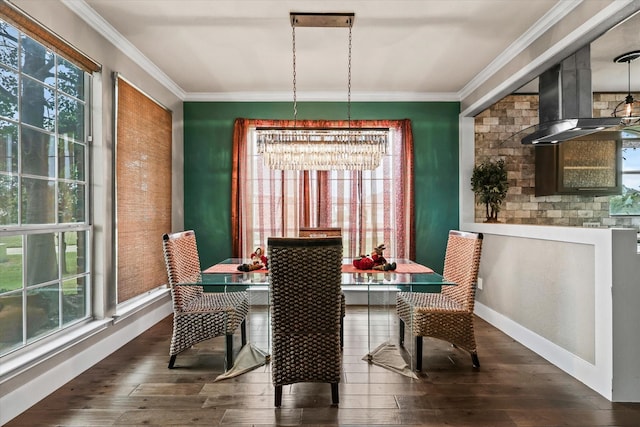 dining area with dark hardwood / wood-style floors, an inviting chandelier, plenty of natural light, and ornamental molding