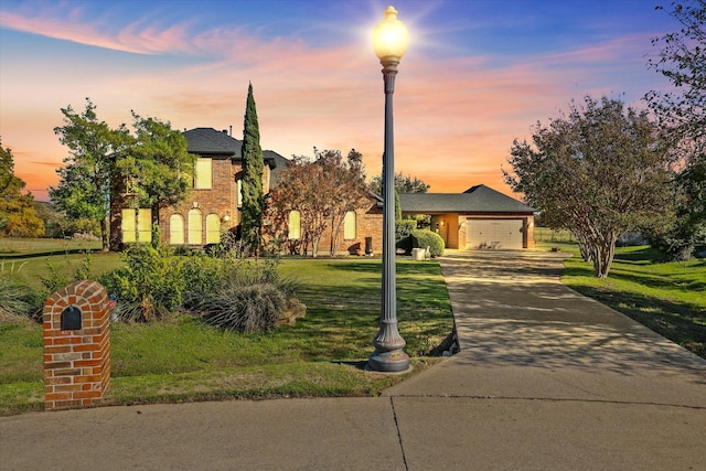 view of front of home with a yard and a garage