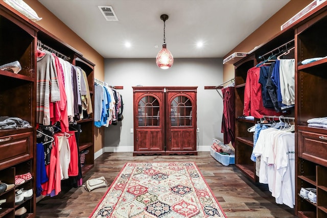 walk in closet featuring dark wood-type flooring