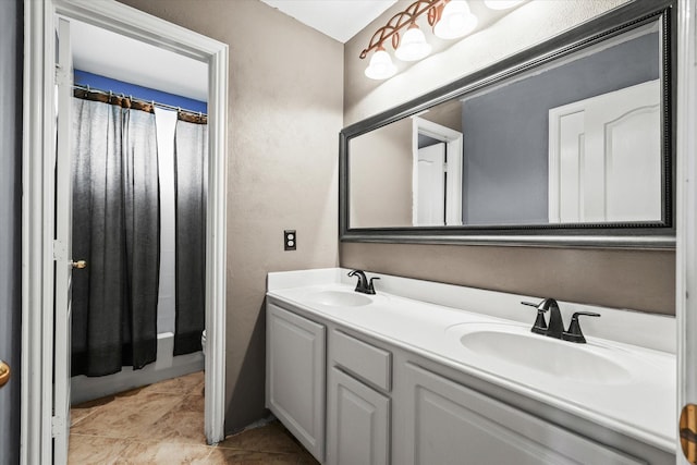 bathroom featuring shower / bath combo with shower curtain, vanity, and tile patterned flooring