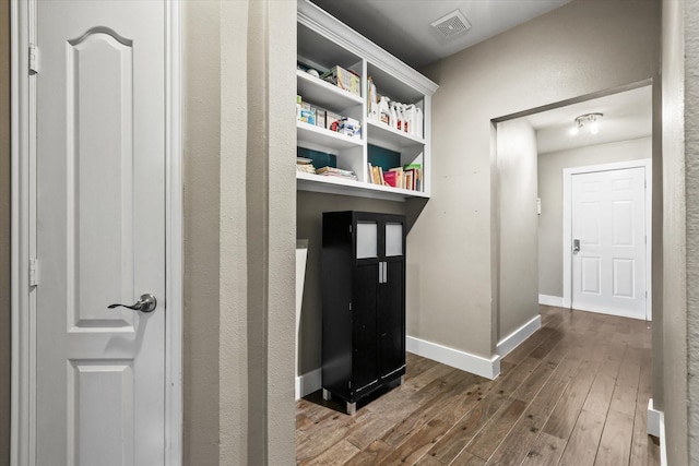 hallway with hardwood / wood-style flooring