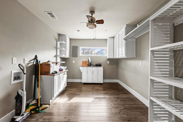 kitchen featuring white cabinets, dark hardwood / wood-style floors, and ceiling fan