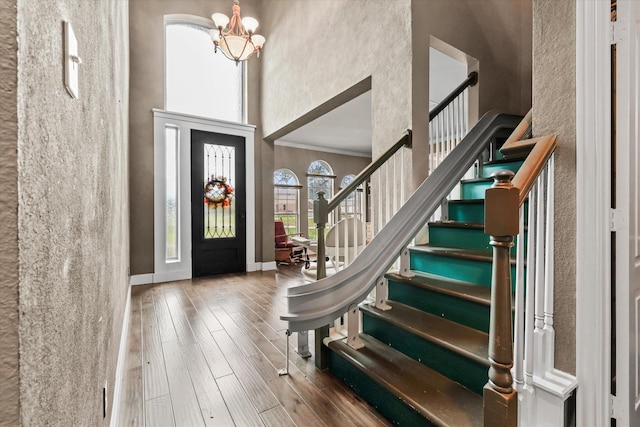 foyer with wood-type flooring and an inviting chandelier