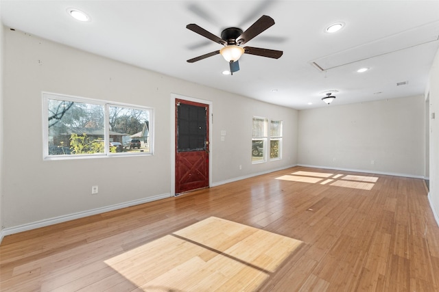 spare room featuring ceiling fan, plenty of natural light, and light hardwood / wood-style floors