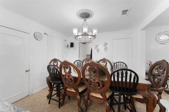 tiled dining room with a notable chandelier and a textured ceiling