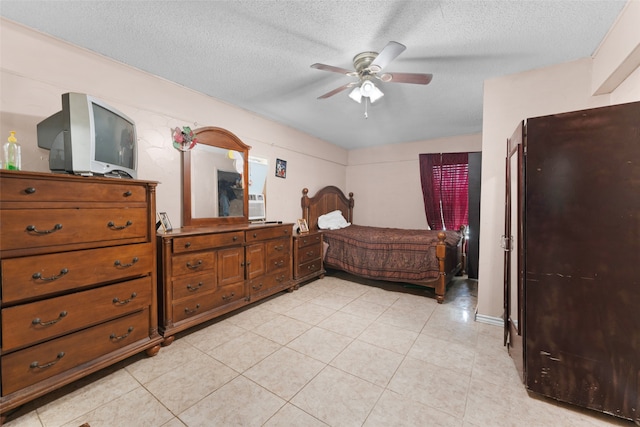 bedroom with a textured ceiling, ceiling fan, and light tile patterned flooring