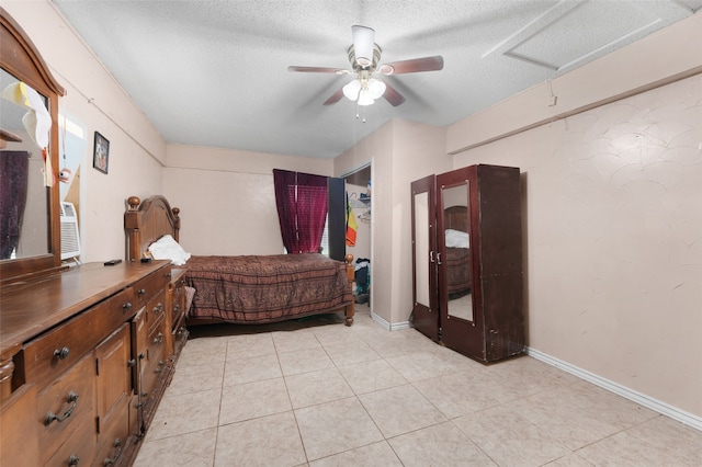 tiled bedroom featuring ceiling fan and a textured ceiling