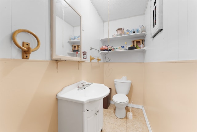 bathroom featuring vanity, tile patterned flooring, a textured ceiling, and toilet