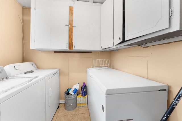 clothes washing area featuring cabinets, separate washer and dryer, electric panel, and light tile patterned flooring