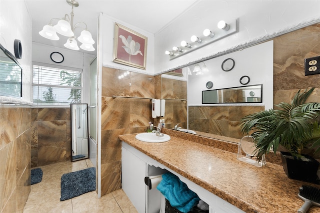 bathroom featuring tile walls, vanity, tile patterned floors, and a shower