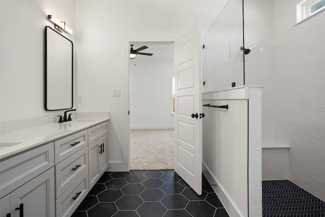 bathroom featuring ceiling fan, tile patterned flooring, vanity, and tiled shower