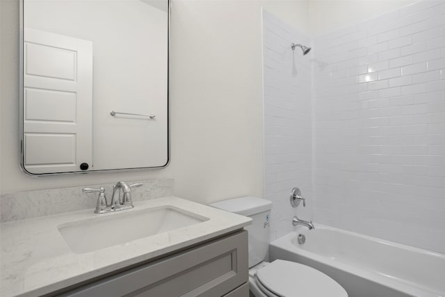 full bathroom featuring toilet, vanity, and tiled shower / bath