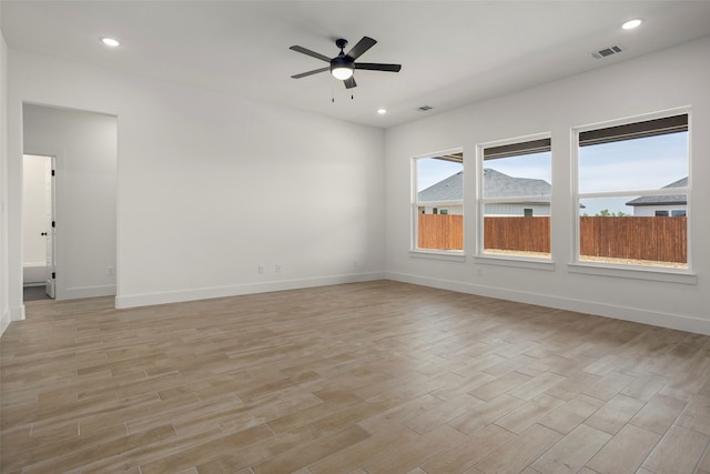 spare room with light hardwood / wood-style floors and ceiling fan