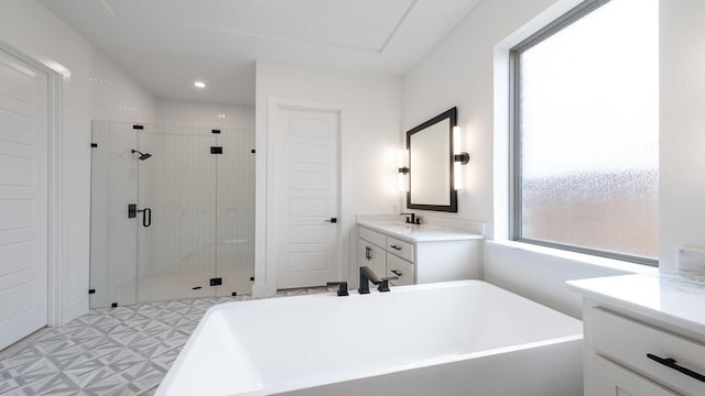 bathroom with tile patterned floors, a stall shower, recessed lighting, a freestanding bath, and vanity