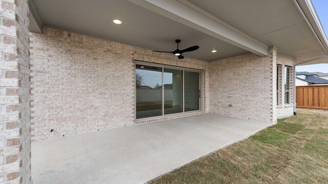 view of patio featuring ceiling fan and fence