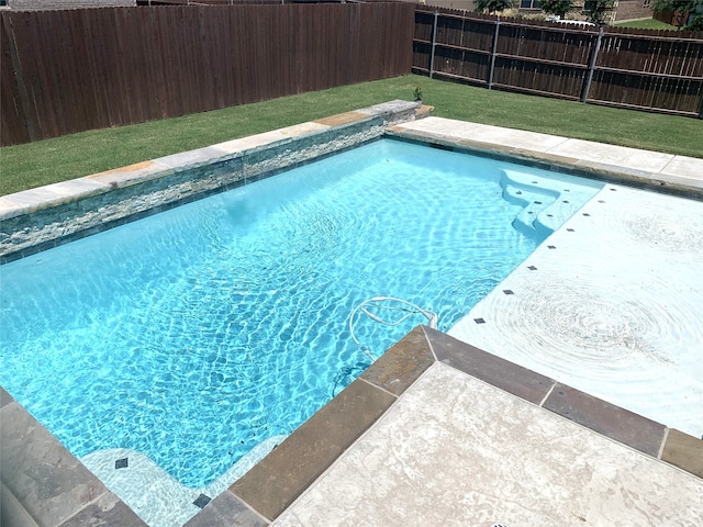 view of pool featuring a yard