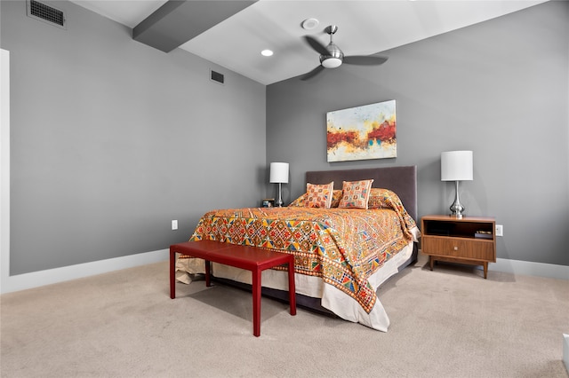 carpeted bedroom featuring beamed ceiling and ceiling fan