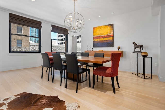 dining room with an inviting chandelier and light hardwood / wood-style floors