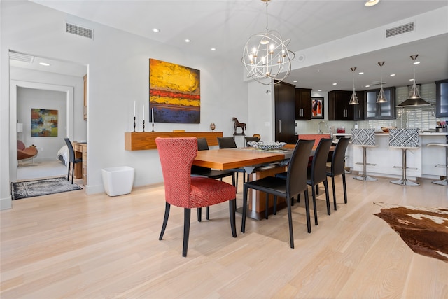 dining room featuring light hardwood / wood-style flooring and a notable chandelier