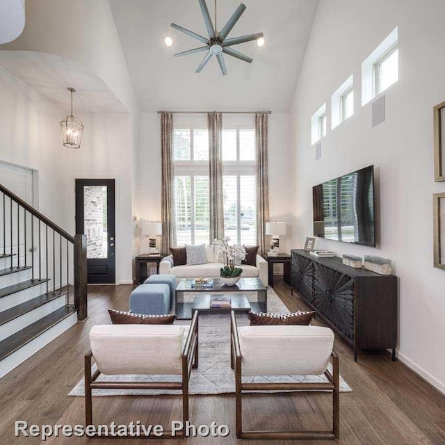 living room featuring high vaulted ceiling, dark hardwood / wood-style floors, and ceiling fan with notable chandelier