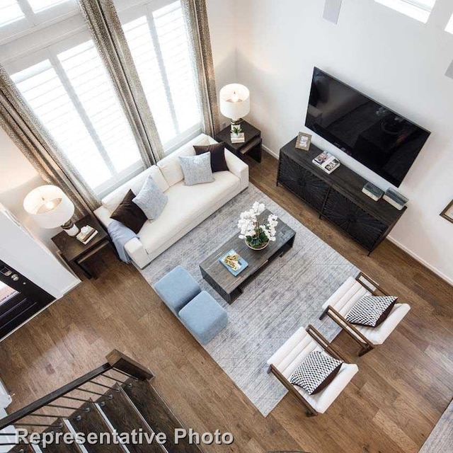 unfurnished living room with dark hardwood / wood-style flooring and a wealth of natural light