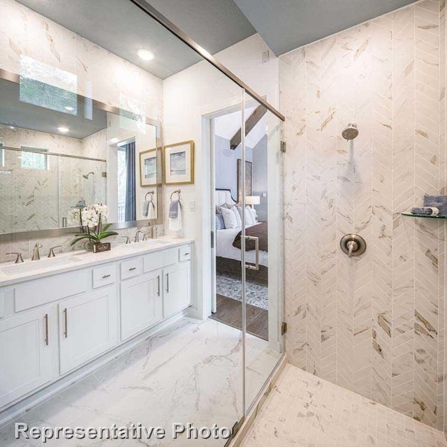 bathroom featuring vanity and a shower with door