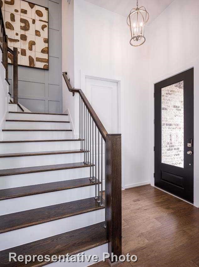 entrance foyer with hardwood / wood-style flooring and an inviting chandelier