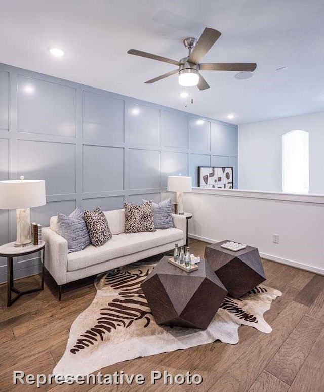 living room with ceiling fan and dark hardwood / wood-style floors