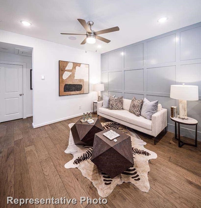 living room with wood-type flooring and ceiling fan