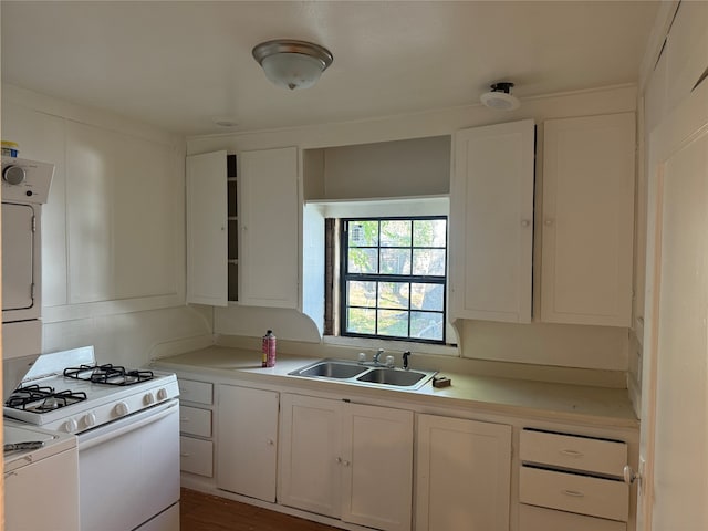 kitchen with dark hardwood / wood-style floors, white cabinetry, sink, and white gas range oven