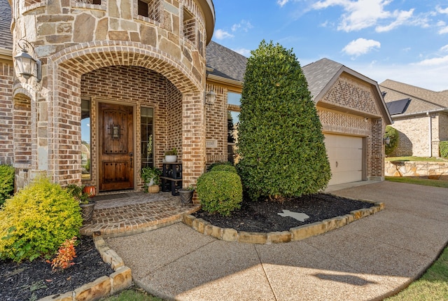 doorway to property with a garage