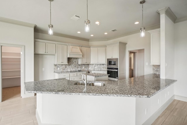 kitchen featuring sink, hanging light fixtures, stainless steel appliances, kitchen peninsula, and ornamental molding