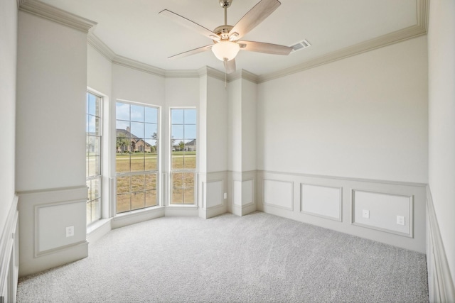 unfurnished room with light colored carpet, ceiling fan, and crown molding