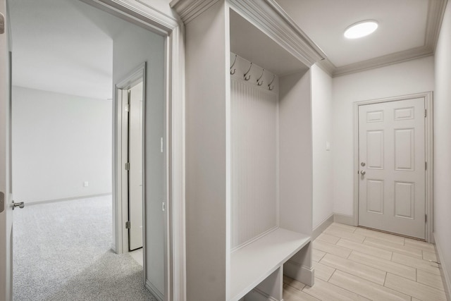 mudroom featuring crown molding and light carpet