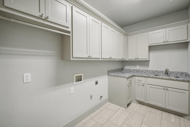 clothes washing area featuring sink, cabinets, washer hookup, electric dryer hookup, and hookup for a gas dryer