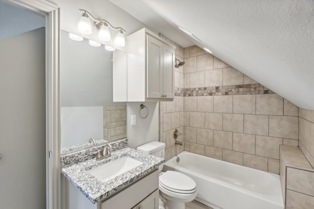 full bathroom featuring tiled shower / bath combo, a textured ceiling, lofted ceiling, toilet, and vanity