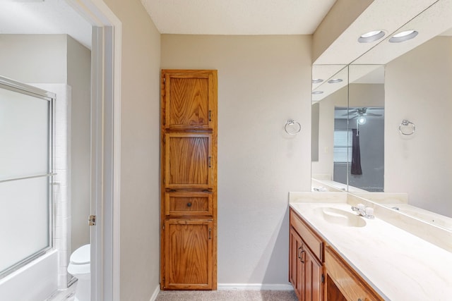 full bathroom with toilet, combined bath / shower with glass door, vanity, and ceiling fan