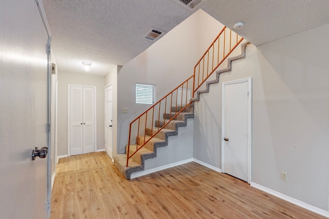 entryway featuring hardwood / wood-style floors and a textured ceiling