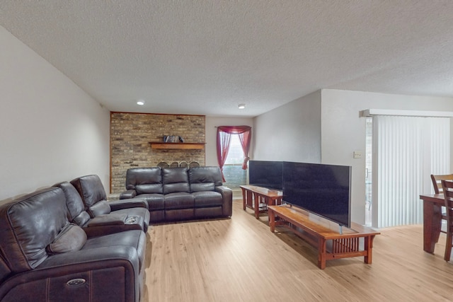 living room with a textured ceiling and light wood-type flooring