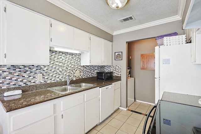 tiled dining space featuring crown molding, vaulted ceiling, a textured ceiling, a tile fireplace, and ceiling fan