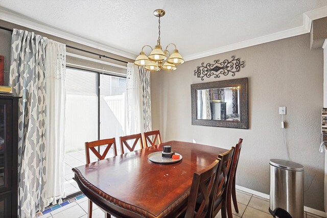 tiled dining room with ornamental molding, a notable chandelier, and a textured ceiling